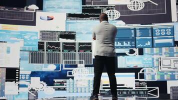 African american guy reflecting on annual financial reports for new development, reviewing the complexity of performance analysis with a focus on productivity and forecasting, AI tools. Camera A. video