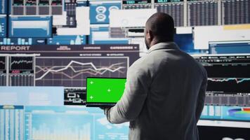 Black executive manager studying copy space screen with data insight for business growth, surrounded by virtual graphs and forecasting models. Financial performance and decision making. Camera A. video