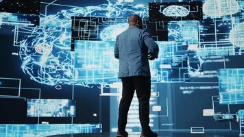 African american engineer examining artificial intelligence brain systems using cloud computing tools and advanced programming. Using machine learning for virtual assistant automation. Camera A. video