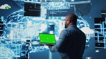 Modern black person in digital space uses isolated display with AI tools, representing artificial intelligence data structures and intelligent systems. Innovation and cybernetics for science. Camera A. video