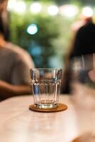 A empty glass of water on table photo