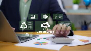 Environmental responsibility, sustainable business practices, renewable energy, and corporate governance. Green business. A person interacting with a holographic display of ESG and Carbon Credit icons photo