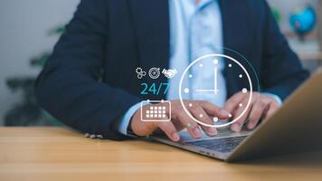 Businessman showing a 24 hour and 7 day icon, symbolizing 24 7 service, online payments, shopping, continuous transactions, and always-on cloud-based business operations for modern digital services. photo