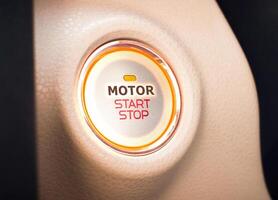 Car start button, MOTOR START STOP switch or Push start with keyless ignition, modern car or electric vehicle concept. photo