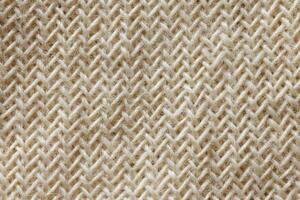 Macro view of rough natural jute textile with detailed woven zigzag structure and earthy texture. photo