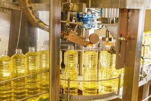 Automated Sunflower Oil Bottling Line in Modern Factory with Industrial Machinery and Transparent Bottles photo