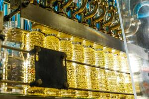Automated Sunflower Oil Production Line in Factory Close Up Bottling and Filling Process of Transparent Bottles photo