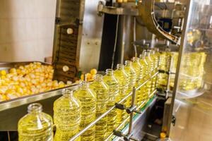 Automated Sunflower Oil Bottling Line in Modern Factory with Transparent Bottles and Industrial Equipment photo
