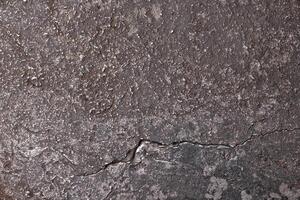 eroded texture steel or another alloy metal background with cracks and scratches photo