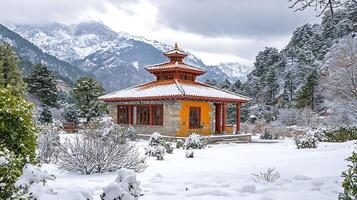 Serene snow covered building nestled amongst snowy mountains. photo