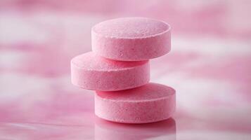 Stack of Three Pink Tablets on a Pink Background. photo