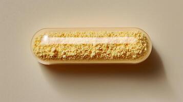 Pharmaceutical capsule with yellow powder filling. A close-up studio shot of a clear gelatin capsule containing a fine yellow granular substance, highlighting its texture and medical purpose. photo