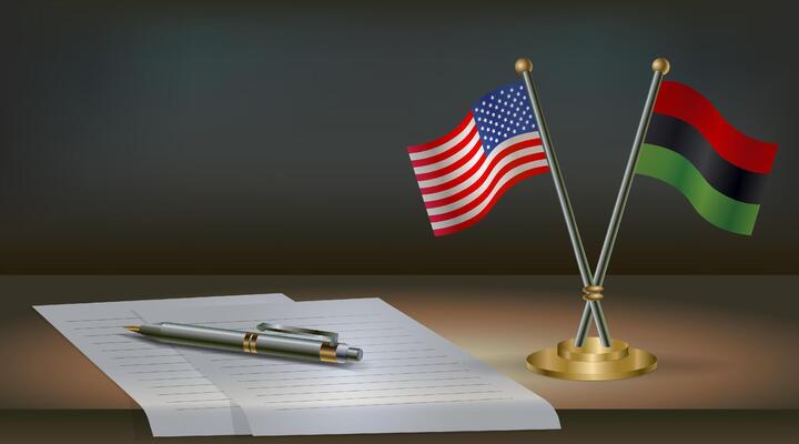 USA and African American flags on table in office. International relations on a dark gradient color background.