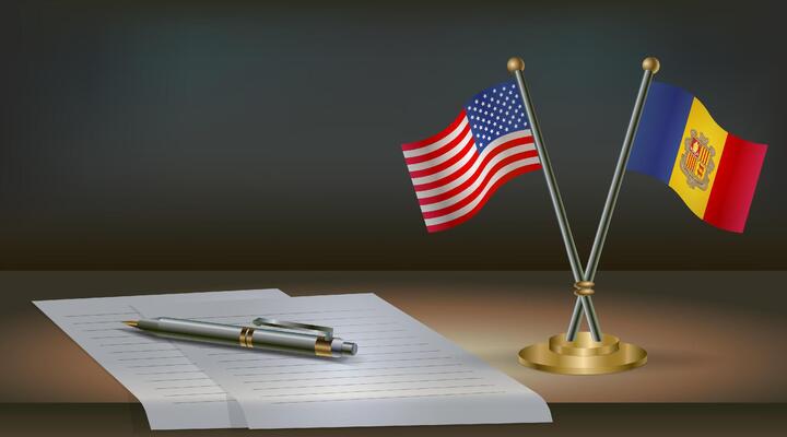 USA and Andorra flags on table in office. International relations on a dark gradient color background.