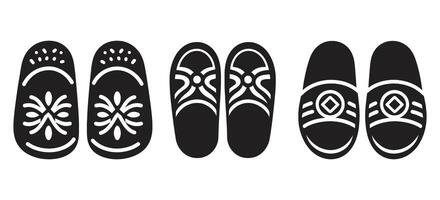 Traditional decorative slipper icon set in black silhouette style with ethnic floral patterns for fashion, footwear, and cultural design use vector