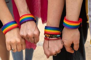 Activists showing support for lgbtq rights with rainbow bracelets photo