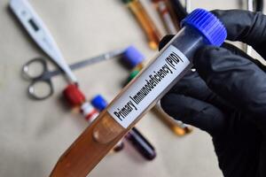 Primary Immunodeficiency - PID - Test with blood sample in black gloved hands. healthcare or Medical concept photo