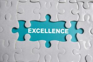 Piece of jigsaw puzzle and word Excellence. photo