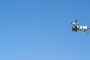 CCTV cameras on the background of a clear blue sky, copy space. Control and safety equipment. surveillance system and face recognition. photo