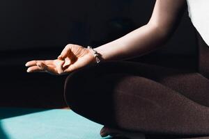 A woman sitting in a yoga pose with her hands open photo