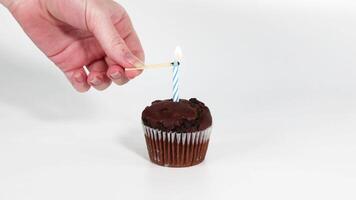A sequence of lighting a candle on a cupcake video