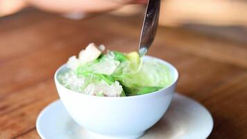 Hands assembling a bowl of green shaved ice video