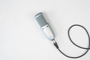 Professional studio condenser microphone on a light background, top view. Audio broadcasting, podcast concept. photo