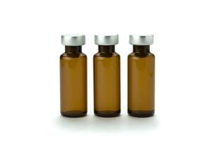 Medical bottle of brown color, for medicine and injection, with a lid, isolated on a white background. Close-up. photo