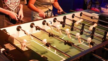 Two players engaged in intense foosball match video