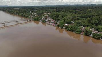 An aerial view of a river with houses and trees video