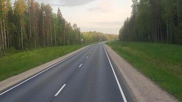 Driving from the passenger's perspective on a smooth, beautiful road through the forest video