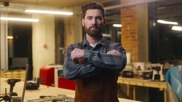 Confident Caucasian man carpenter crossing arms posing in workshop serious wood master builder male small business designer guy constructor working carpentry job artwork craftsmanship artist woodwork video