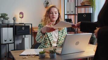 Caucasian freelancer accountant receiving documents from boss and working with financial graph, calculate taxes for charts and reports in home office. Girl working on laptop, planning expenses budget. video