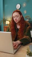 Happy Caucasian woman closing laptop pc after finishing work . Girl freelancer working online, remote job at home office table workplace. E-learning, browsing internet on notebook computer. Vertical video