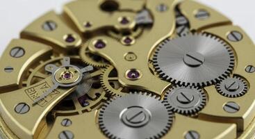 Macro view of intricate golden gears and ruby jewels inside a vintage mechanical watch movement photo