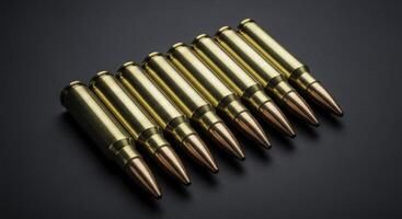 Eight 7.62 caliber rifle cartridges in a row on a dark surface photo
