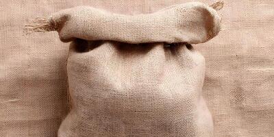 Brown Burlap Sack on Burlap Background Empty Sack Texture photo