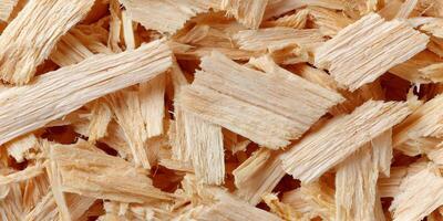 Natural woodchip texture background with scattered light brown shavings photo