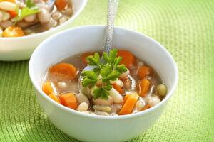Vegetable soup with bean and carrots photo