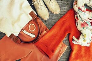 Autumn female outfit. Set of clothes, shoes and accessories on grey background photo
