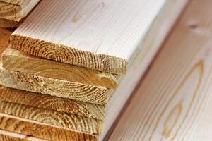Pile of new wooden boards on a storage. Side background texture photo