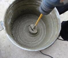 Concrete mixing with electrical drill photo