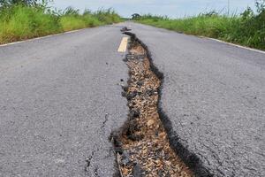 a crack in the road that is showing a crack in the road photo