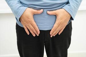 Hernia, man stomach ache, abdominal pain and urology problem health. photo