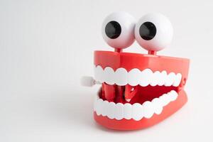 Funny red teeth with eye toy denture model for dental photo