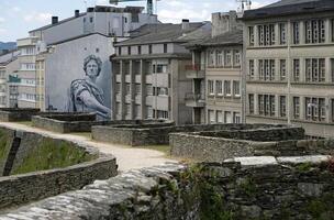 Lugo, Spain - 17 April 2025 - Street art and ancient Roman wall - view of Lugo, Galicia, Spain photo
