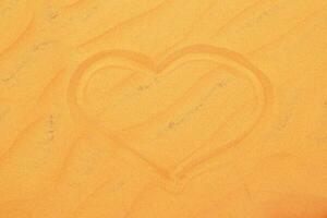 Heart Shape in Sand. A Symbol of Love and Affection on a Sandy Beach Surface. photo