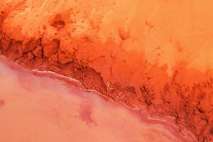 Abstract Landscape. Texture of Eroded Red Soil and Water Meeting. Mui Ne, Vietnam, Fairy Stream. photo