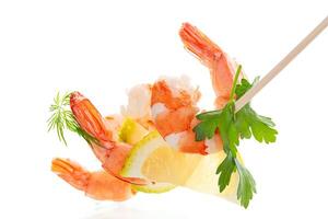 Ready to eat red shrimps with lemon isolated . photo