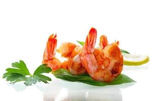 Cooking fried shrimps with aromatic spices and lemon isolated on white photo